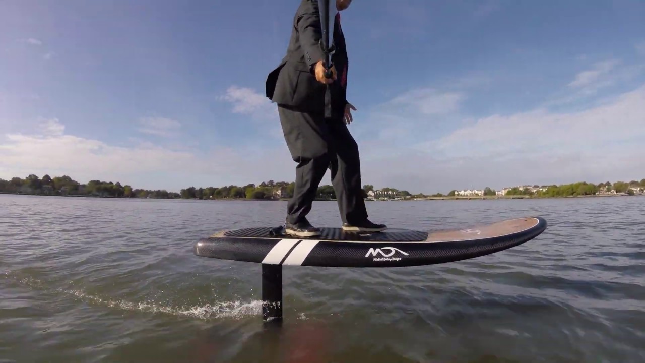 Man in suit and tie riding an Electric Foil board ... Will dry suit be a wet suit?