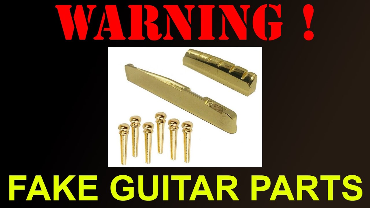 Brass acoustic guitar nut, saddle and peg set. . . fake brass guitar parts?