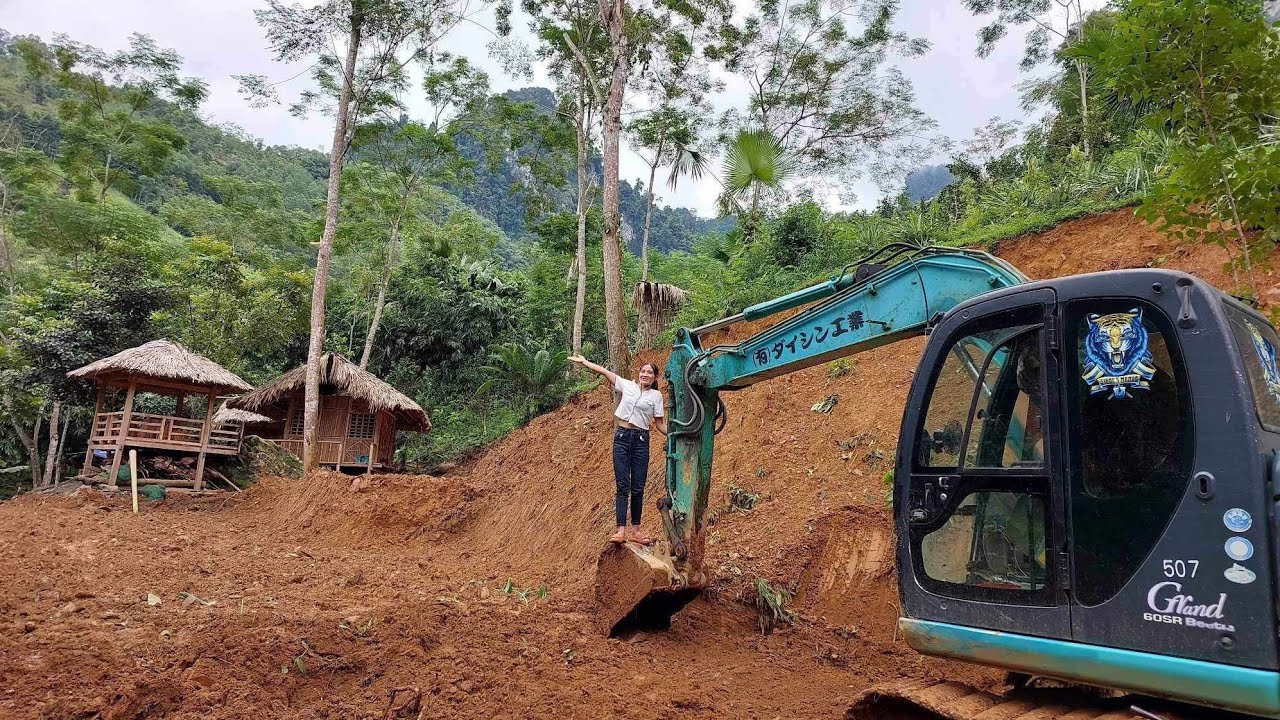 With the help of powerful machinery, the girl leveled a large area to create a farm in the forest.