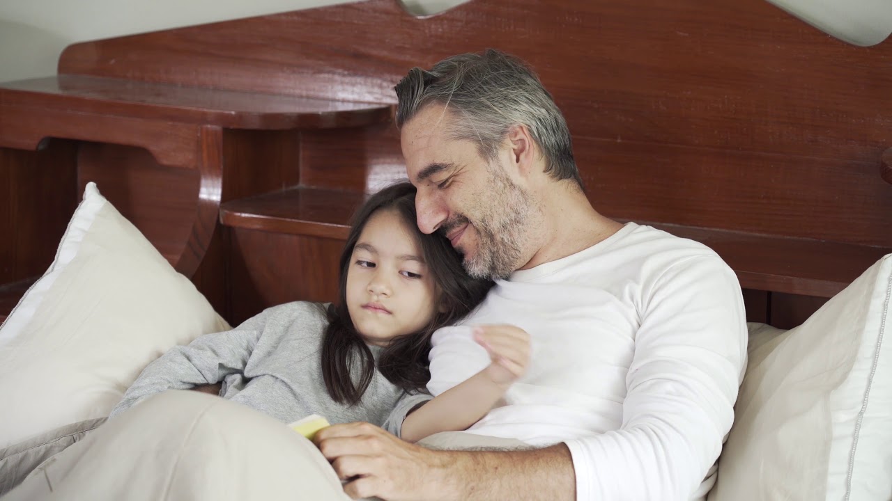 Copyright free 4k stock footage || father reading a book for his child