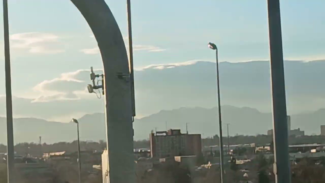 Entering Downtown DENVER, Colorado w/ Rocky Mountains in Background TRAVEL.Nick123.com