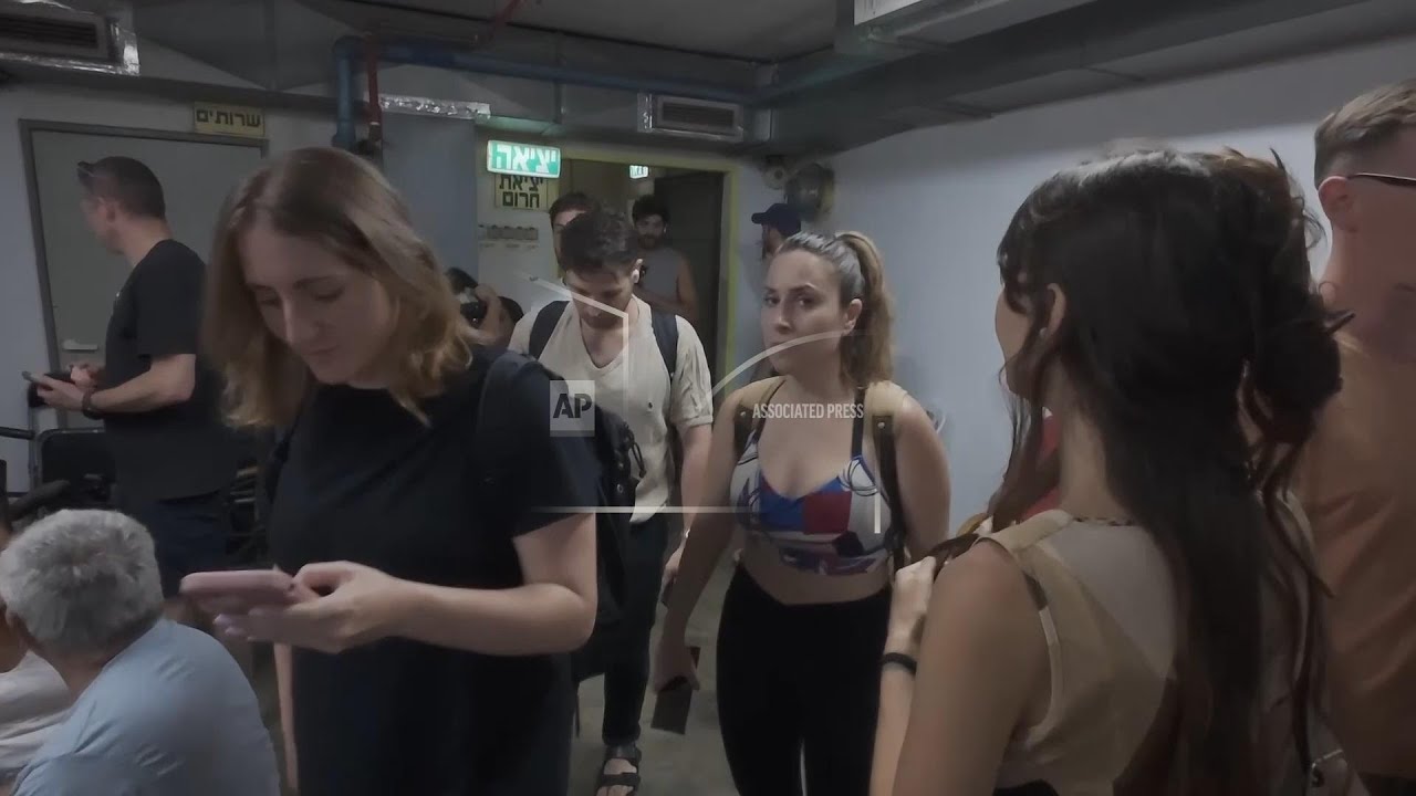 Residents of Tel Aviv move to a shelter after sirens sound over city