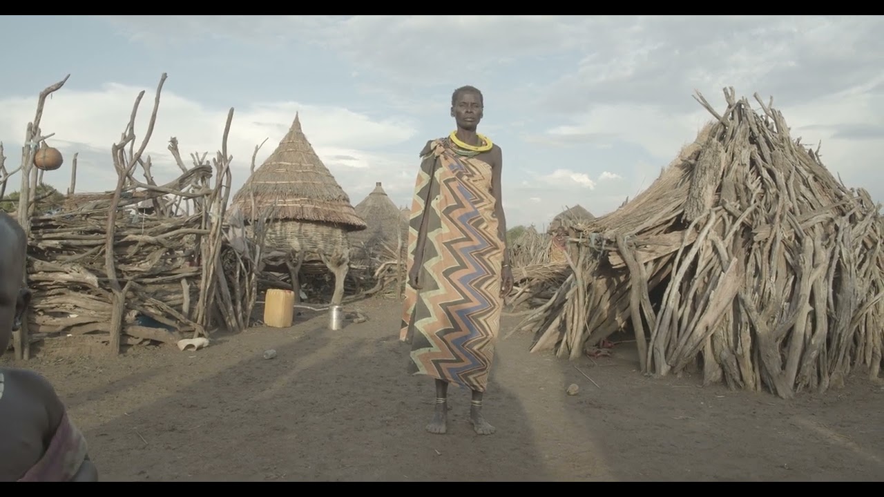 Toposa tribe woman in traditional clothing in a village, Namorunyang State, Kapoeta, South Sudan