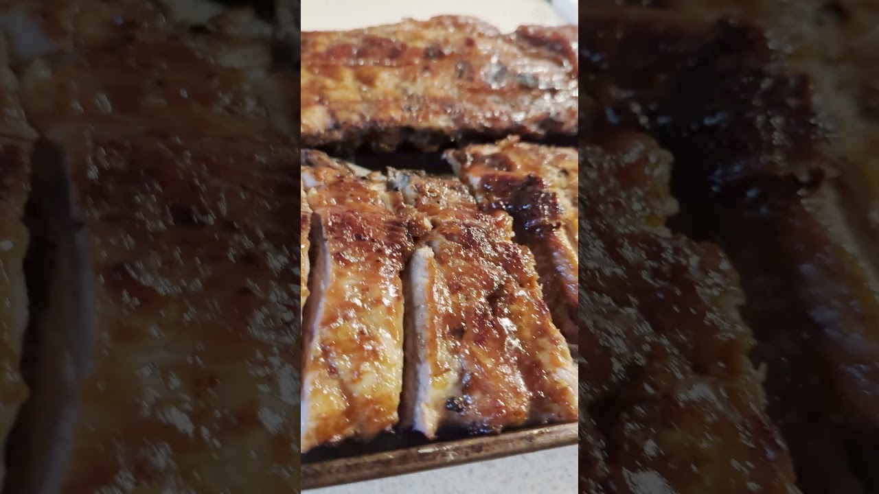 Tommy Fixin his Barbecue Ribs on the Grill  