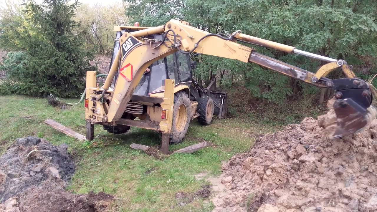 Cat 428c pogłębianie stawu
