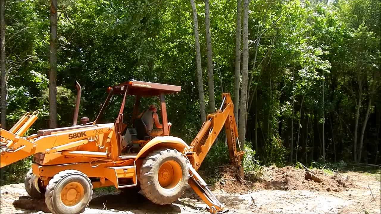Case 580K Backhoe Clearing Trees