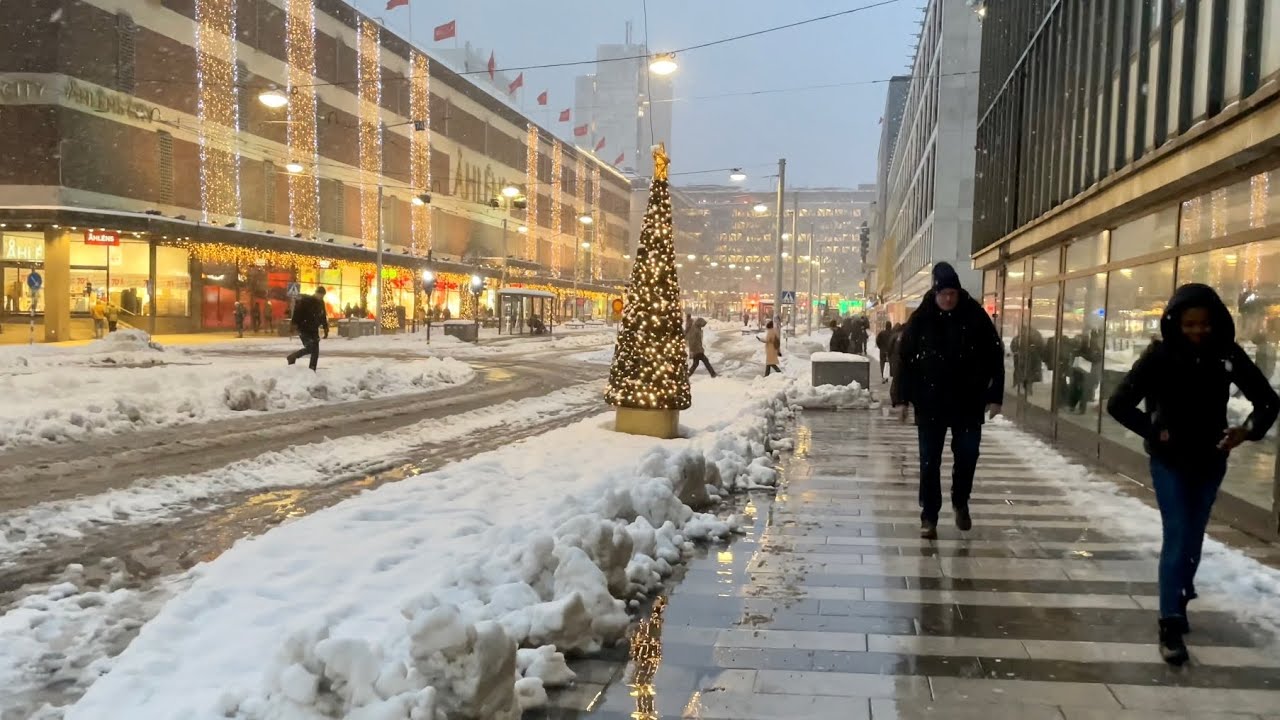 Snowy walk in the heart of Stockholm. Christmas lights, people, noise and bad weather