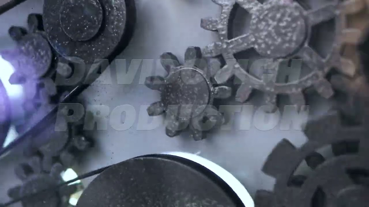 Gears interlocking with belt mechanism in an industrial machine, demonstrating technology