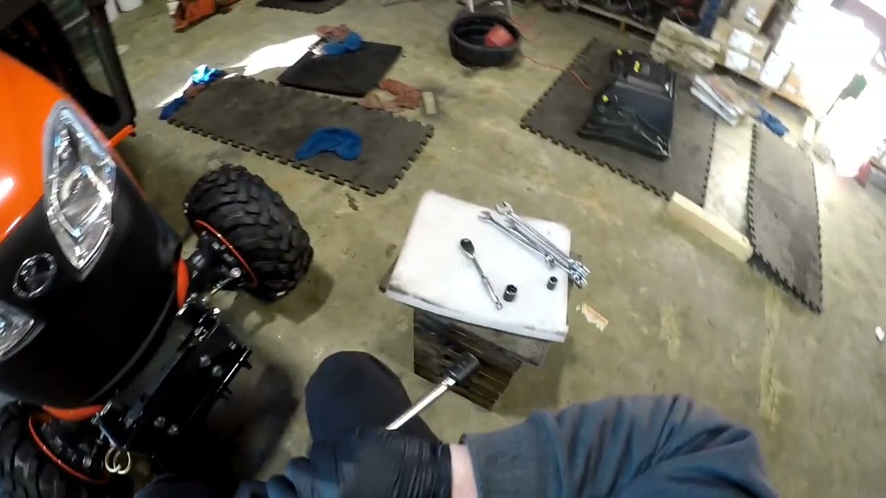 preparing the front of a Kubota bx tractor for a quick hitch