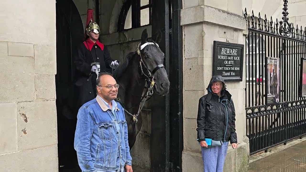 POURING WITH RAIN at Horse Guards - one couple seize the moment
