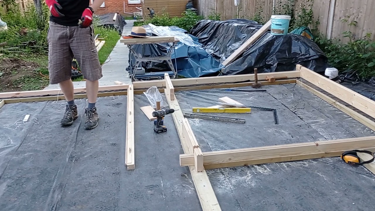 Day 2 of Log Cabin garden office build: laying the first row of logs