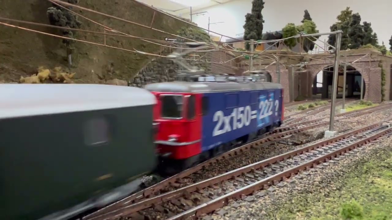 Marklin DB V200 passes my HAG SBB Re 4/4 Passenger Train 