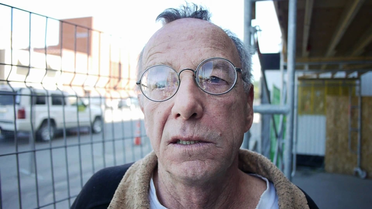 Richard sleeps on the floor of a homeless shelter waiting for more transitional housing to op