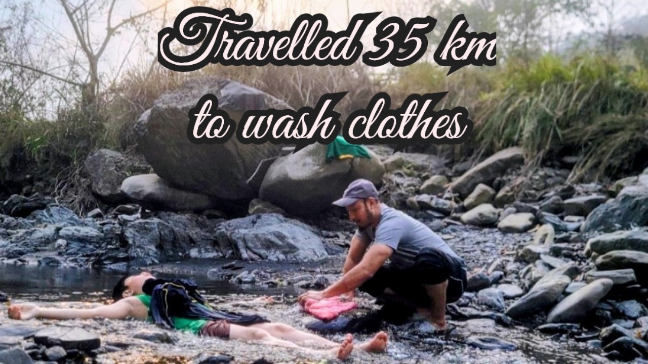 Washing clothes in the river with my son