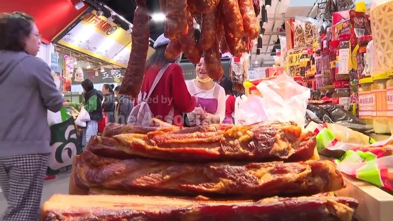 People flock to a market  in Taipei to buy food for year-end family dinner