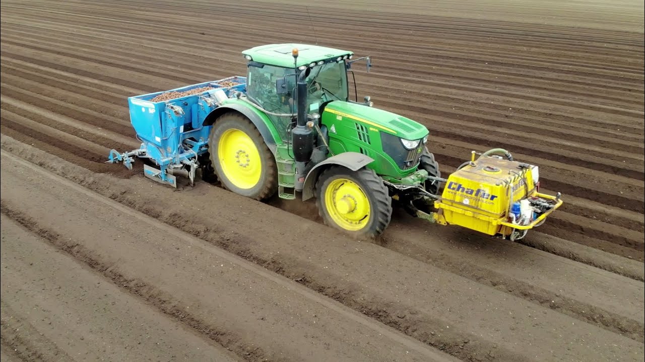John Deere 6195R with a 4 Row Standen Pearson Cup Potato Planter