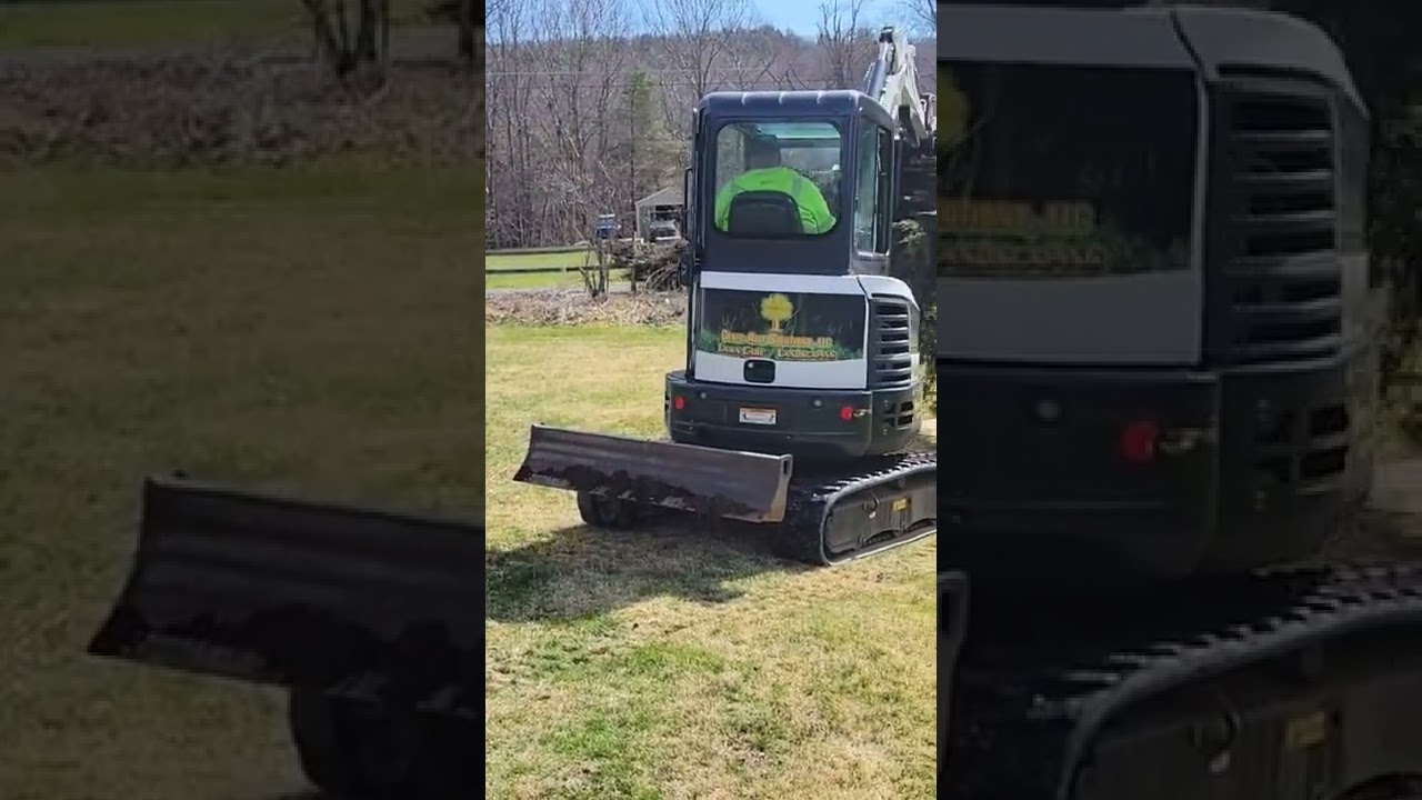 The Bobcat E26 making quick work tearing out overgrown junipers.