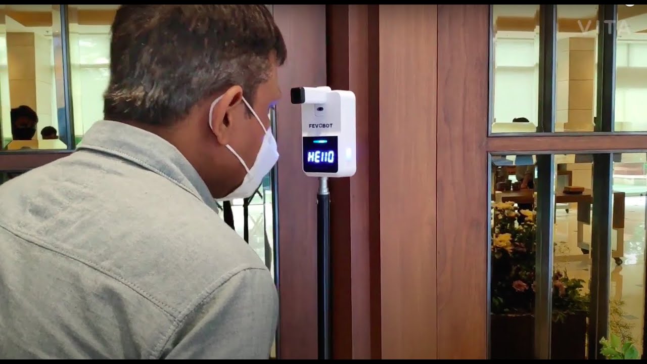 Fevobot automatic wall mounted thermometer installed at a Social function