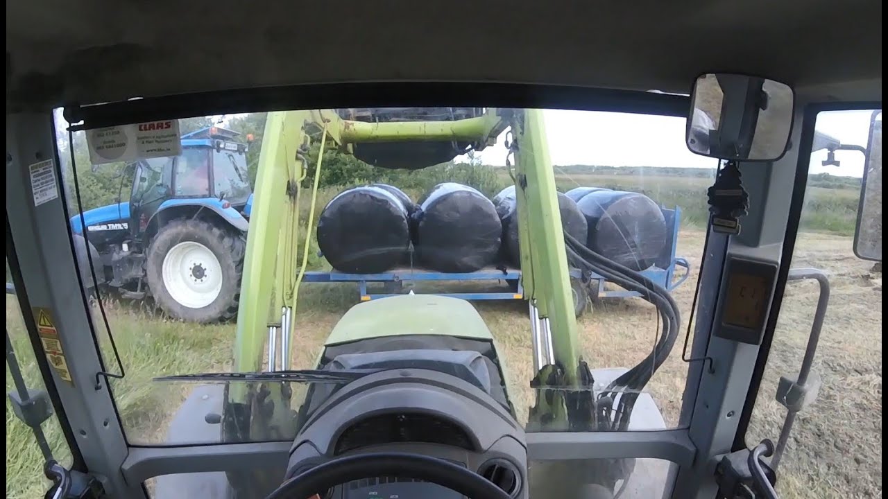 Claas 557atz and TM165 drawing bales