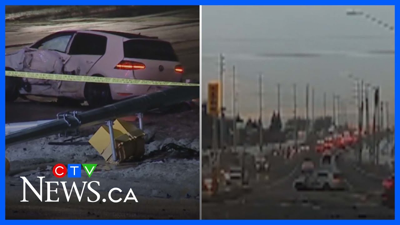 Watch dashcam footage of two cars colliding and knocking down traffic light