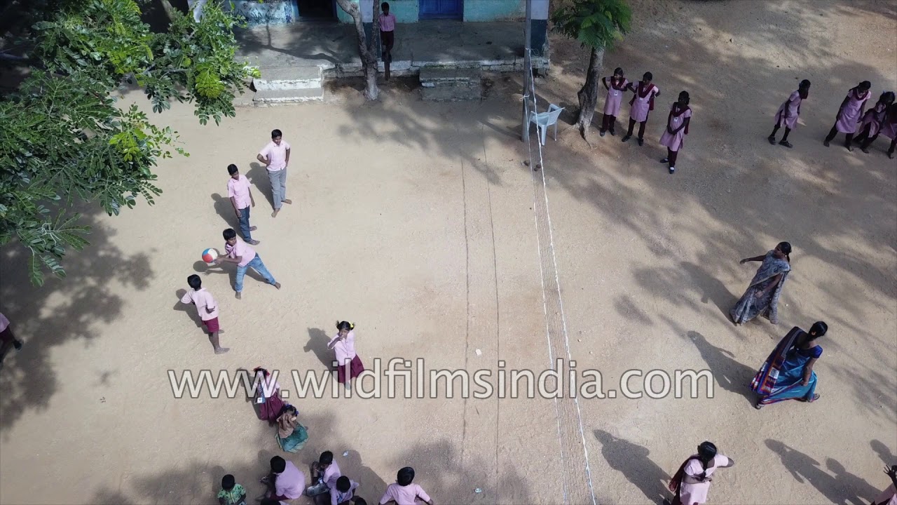 Aerial view of children playing kabaddi - Going to school in India