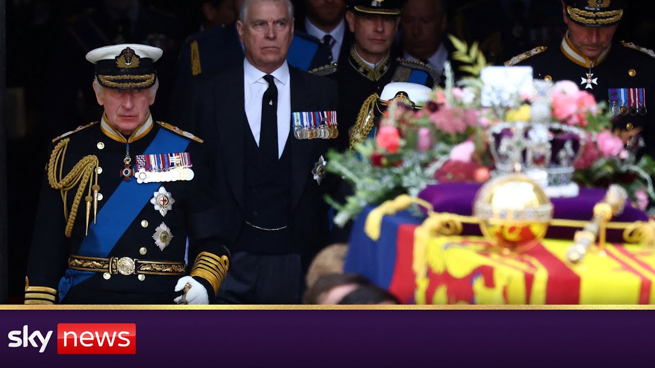 King Charles follows his mother's coffin down the aisle