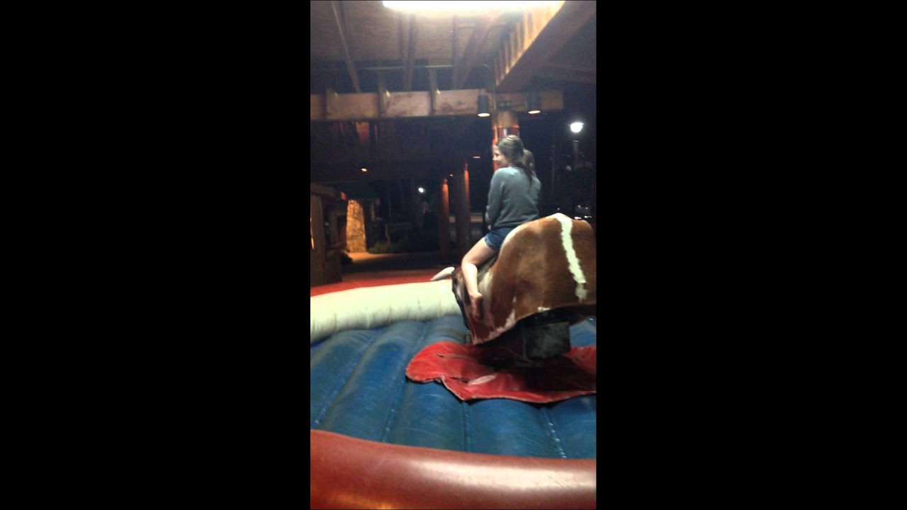 Little girl rides mechanical bull and does really good