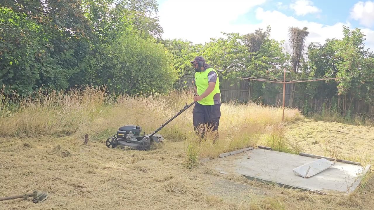 Cutting a overgrown lawn 
