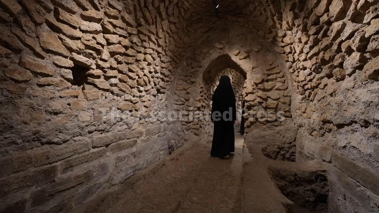 Visitors explore Iraq's history through a recently-discovered underground mosque