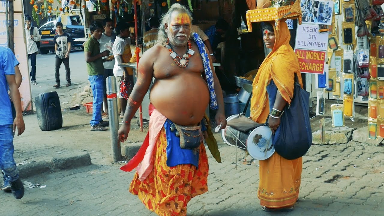 Indian street beggars.Patta wala Baba,Gunghru Baba at busy street of Mumbai,India.भिखारी.beggar