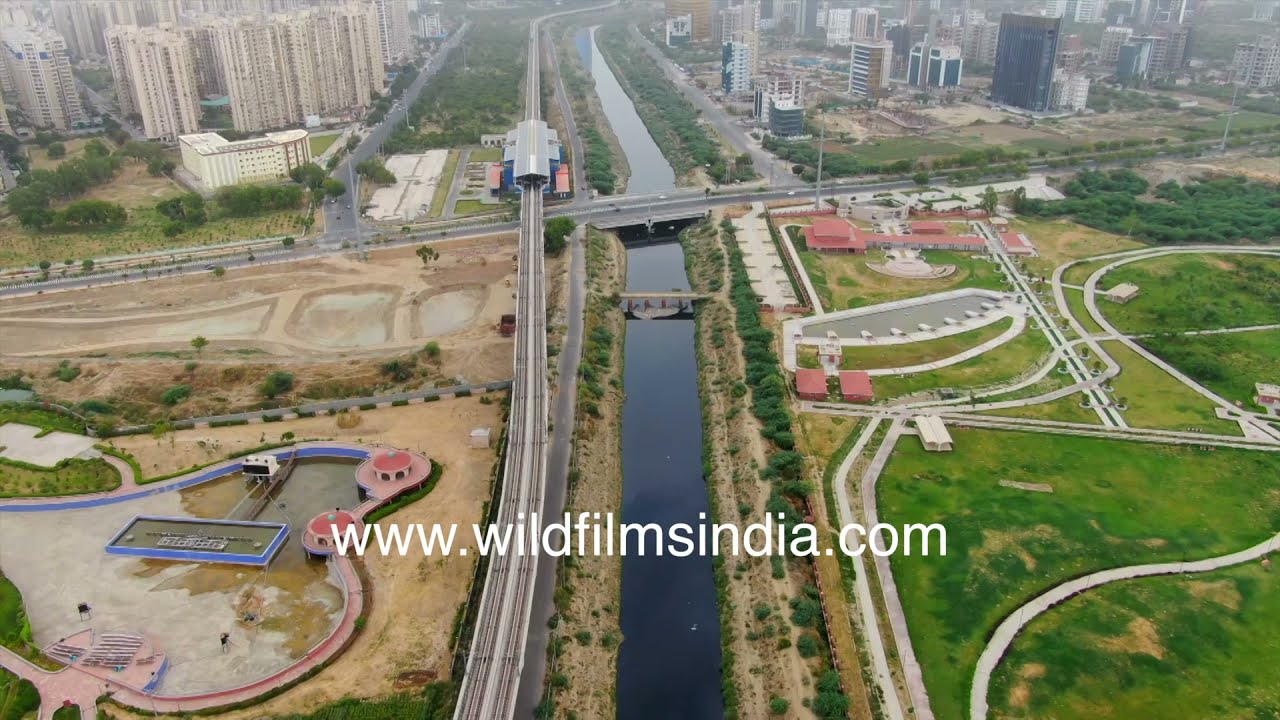 Yamuna river canal flows through Noida mixed land use residential developments, farmland, commercial