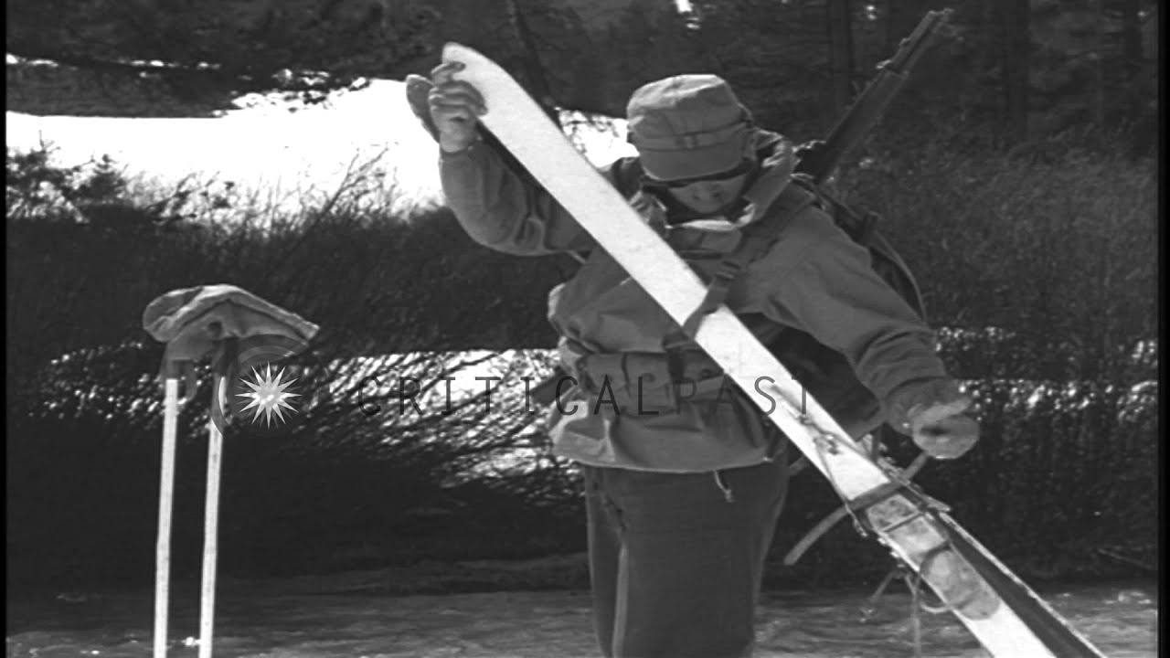 A skier removes the skis and fastens them with a strap to carry them conveniently...HD Stock Footage