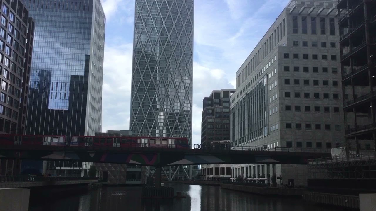 Two DLR trains crossing over a bridge at Heron Quays on 12/9/21