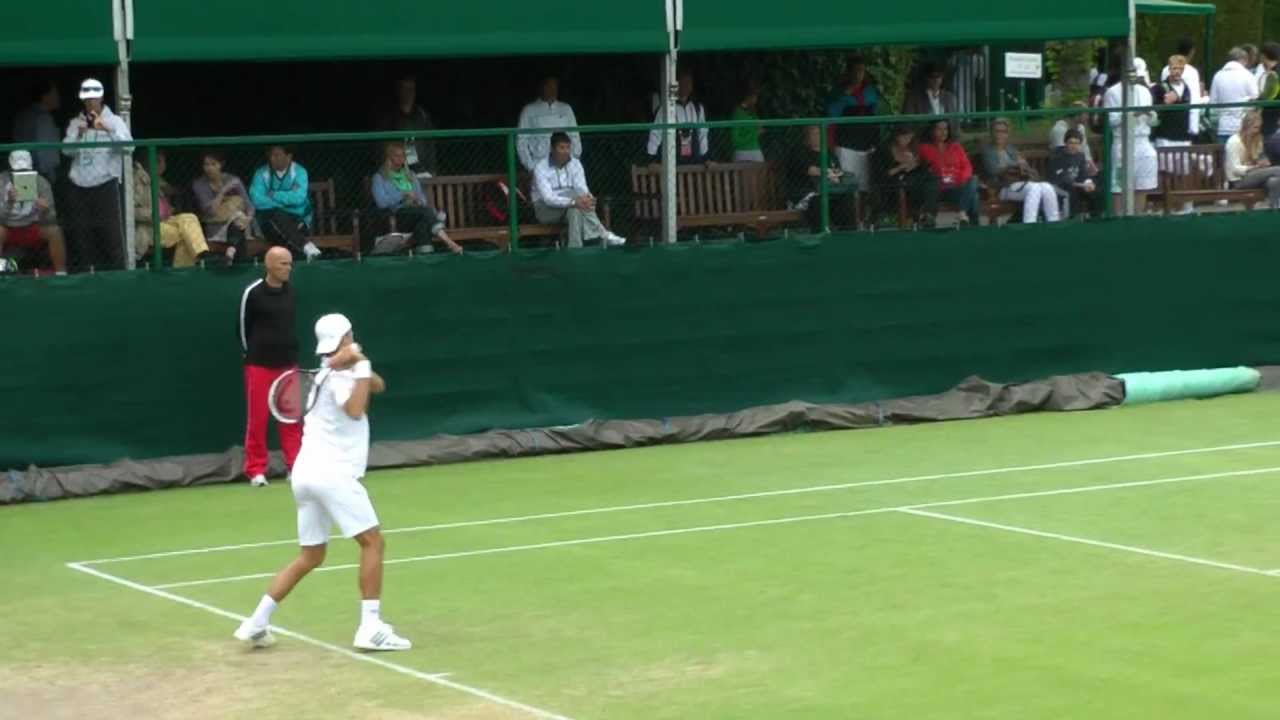 Nikola Milojevic practicing with Novak Djokovic at Wimbledon