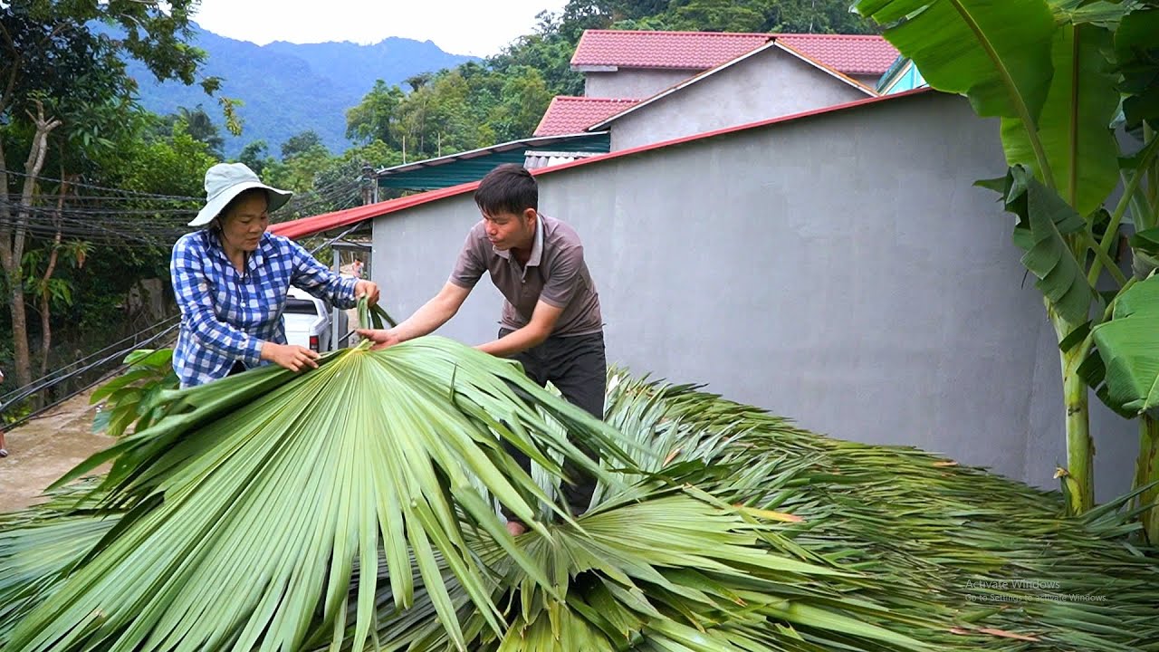 The process of realizing the dream: Roofing with palm trees, working in the rain.  NHAT's dream