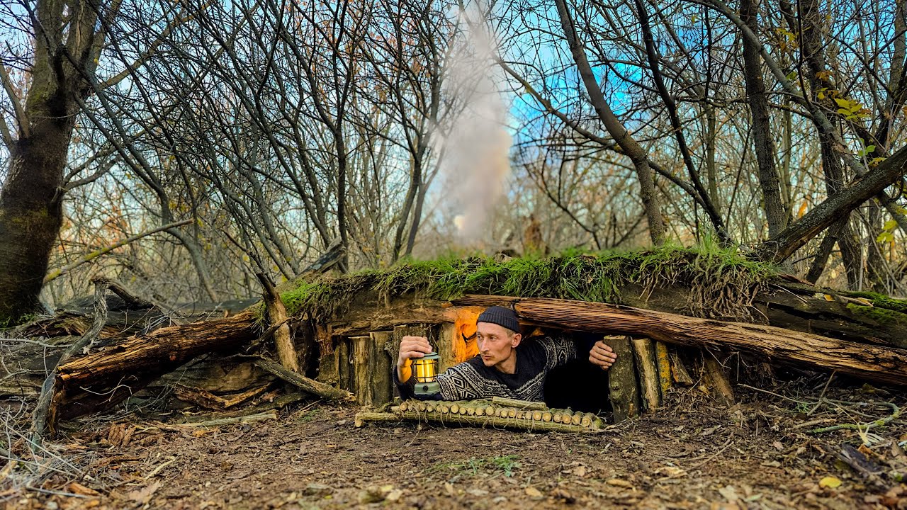 Construction of a secret dugout under the rubble of an old tree. Fireplace made of a log in clay.