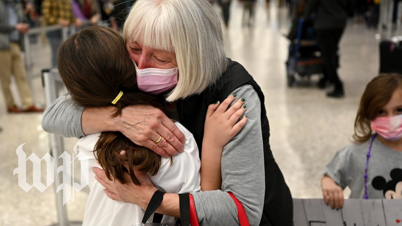 Families share tearful reunions as U.S. ends international travel ban