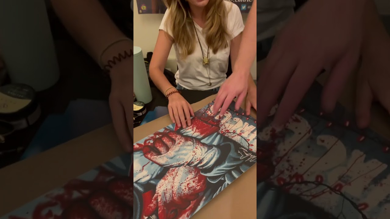 Actress C￼atherine Corcoran & Micheal Leavy, admiring the Terrifier Poster.