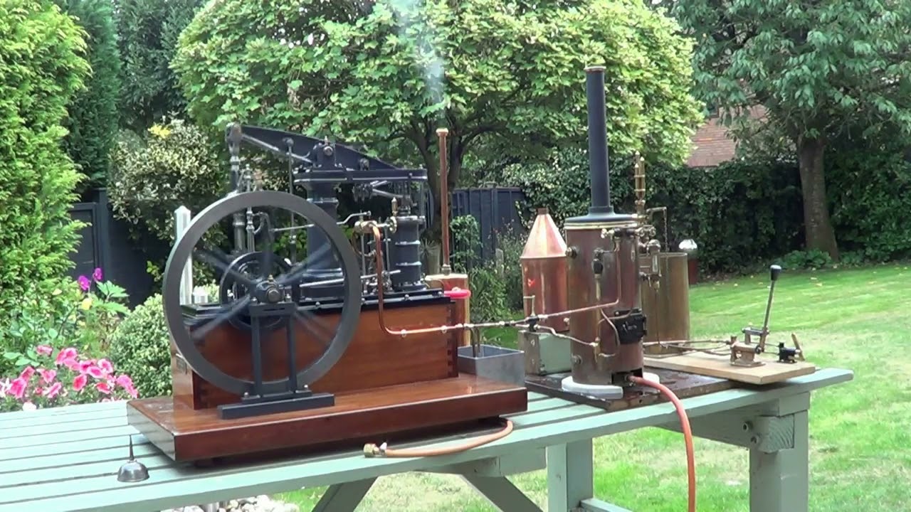 Stuart Major model beam engine in the garden driven by a six inch diameter vertical boiler.