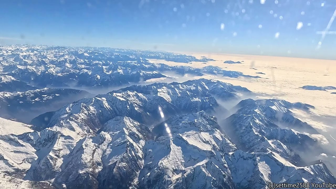 Flying Over Snowy Mountains. Italy. Flight from London to Milano