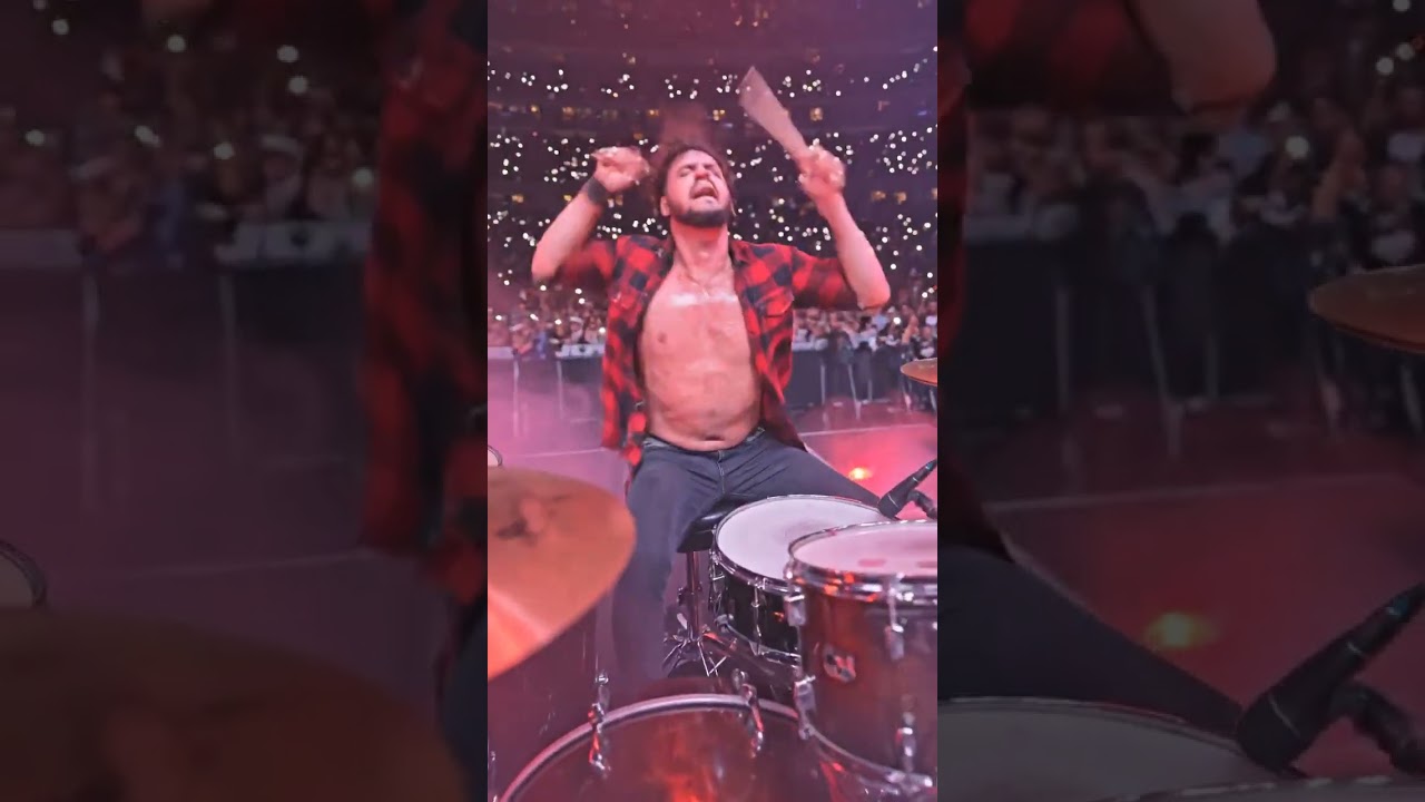 me a heavy metal drummer smashing drums in stadium 
