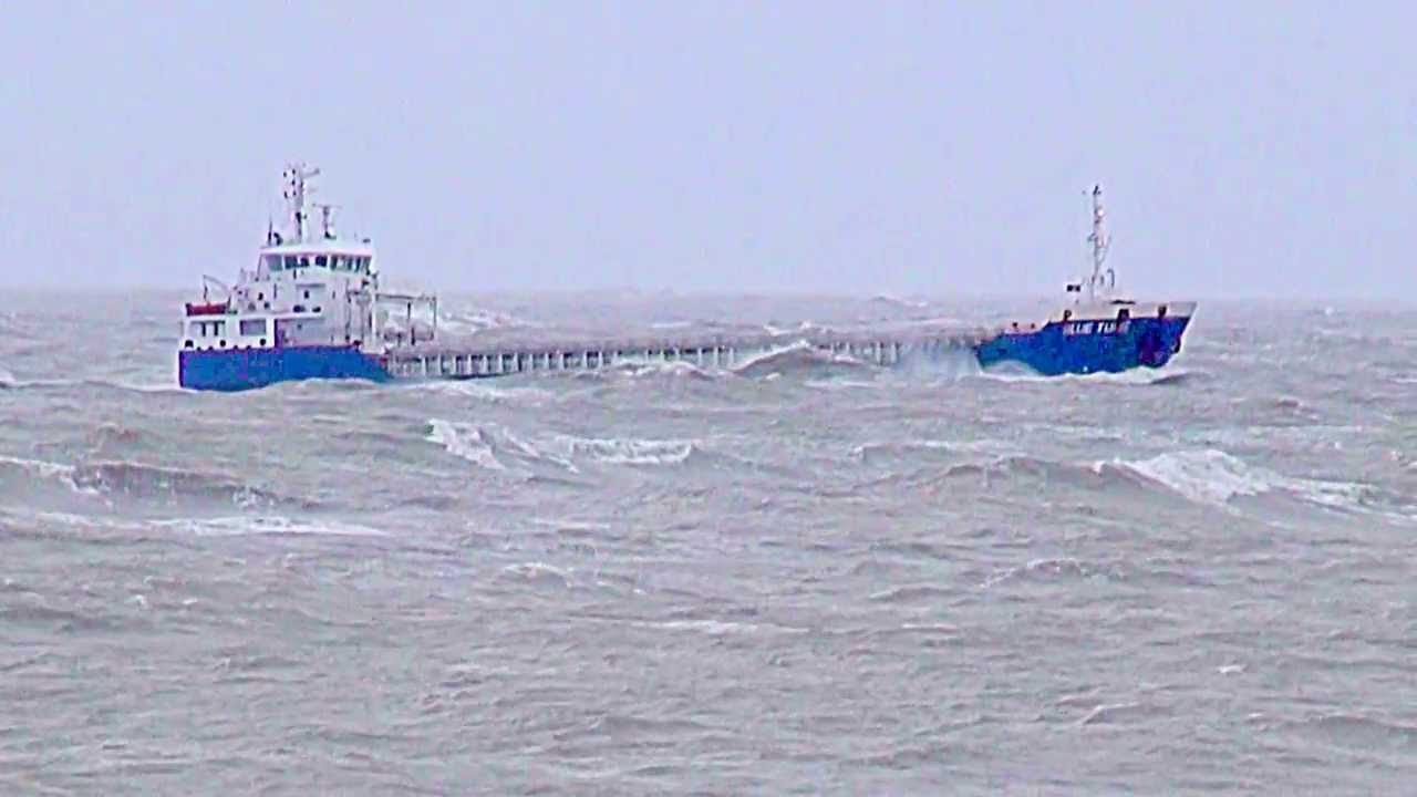 Small cargo ship navigating around Portland Bill