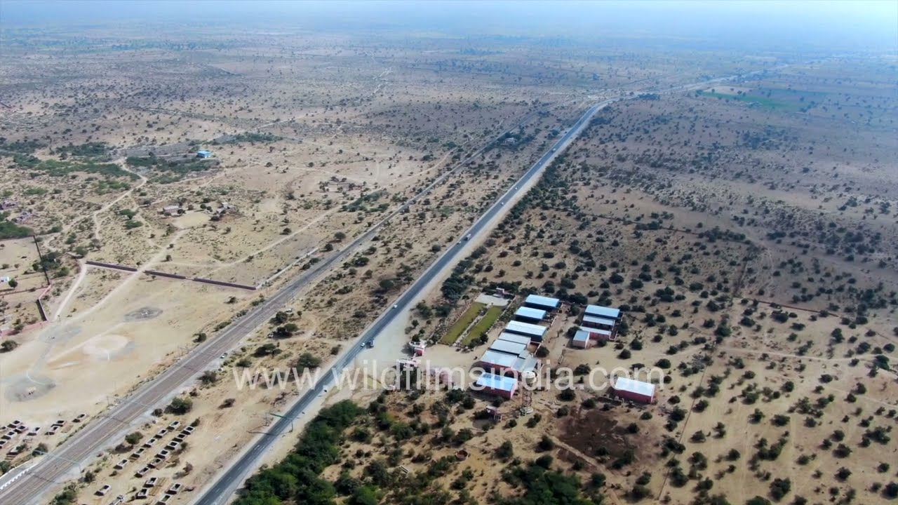 Bikaner desert town aerial view at edge of Indian Thar desert, highway cuts across arid landscape