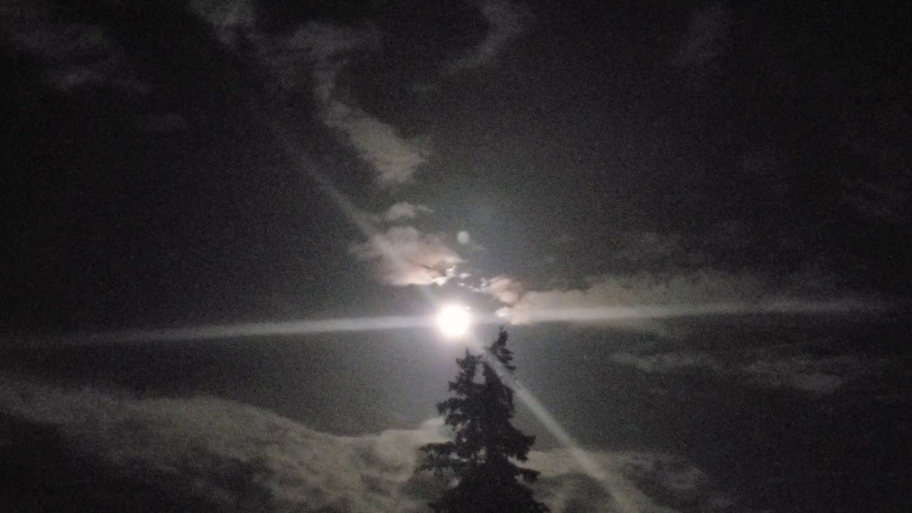 The Moon with Rainbow Spectrum Clouds