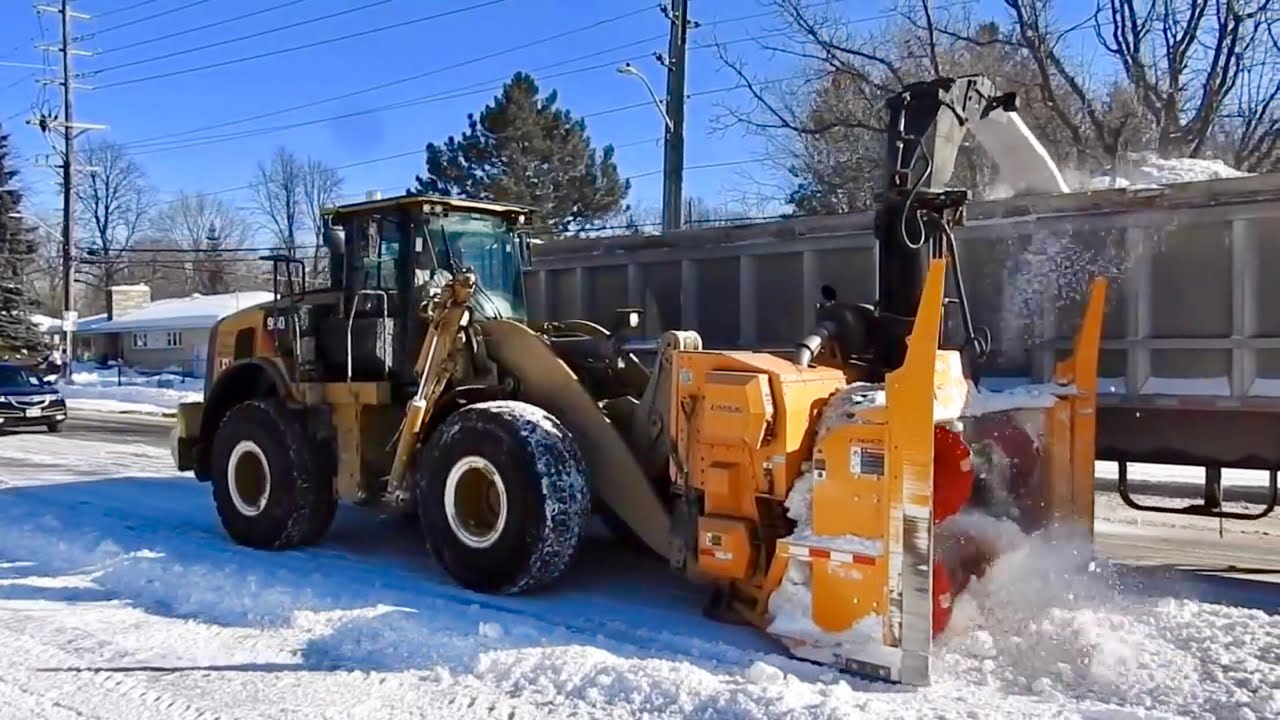 Snow Removal Operation Plowing Snow then Blowing into Trucks