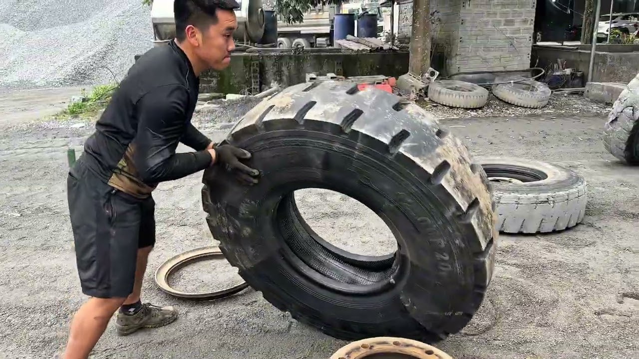 Rescuing and changing tires on 3-axle dump trucks is Giang's daily job.