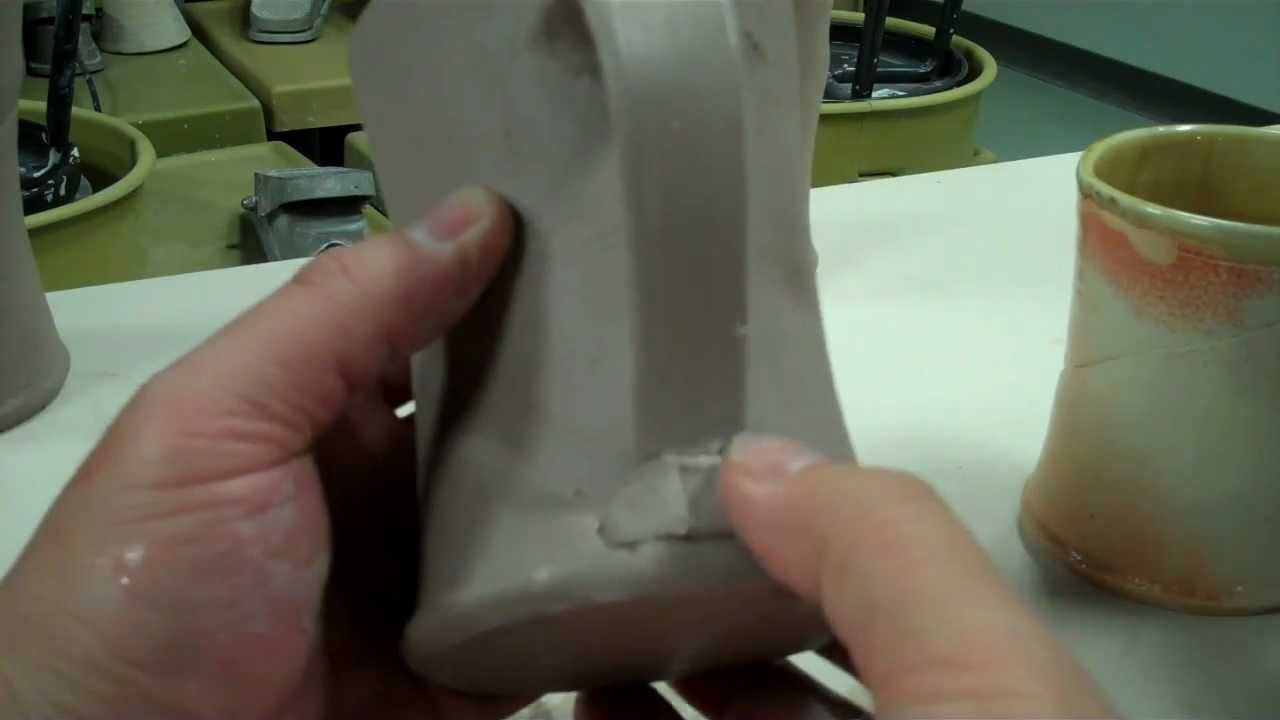 How to pull a handle off the cup. Pottery making.  Making a clay or ceramic mug.