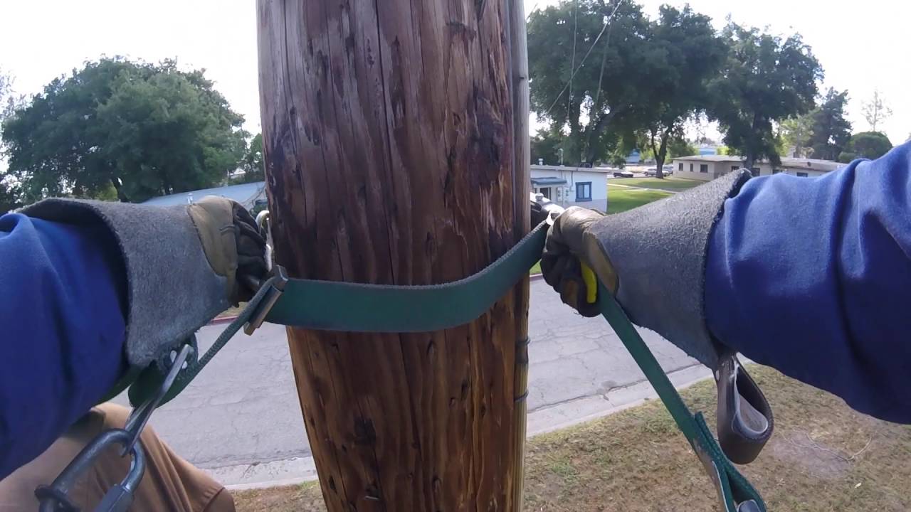 Climbing a pole to hook up a service drop