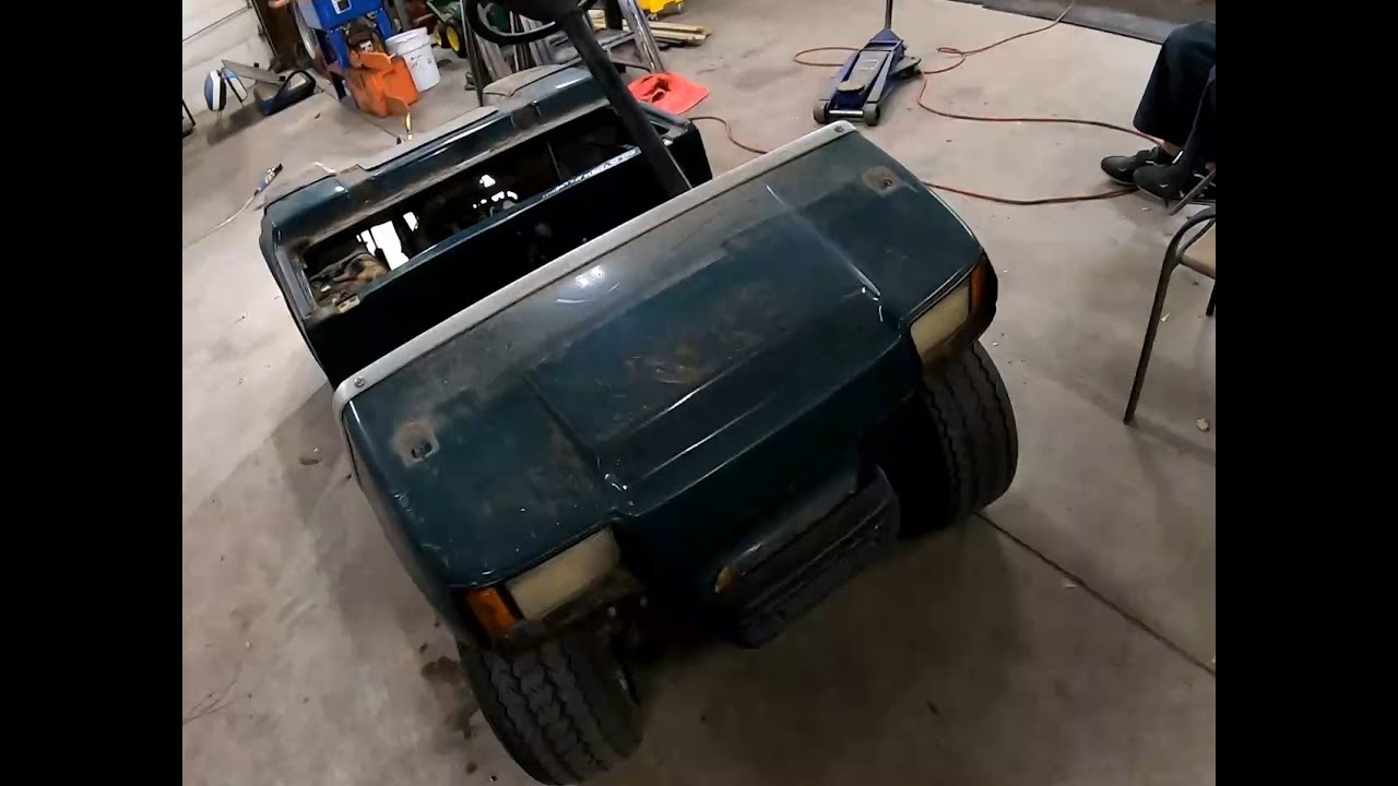 2006 Club Car golf cart Pulling the gasoline engine out.
