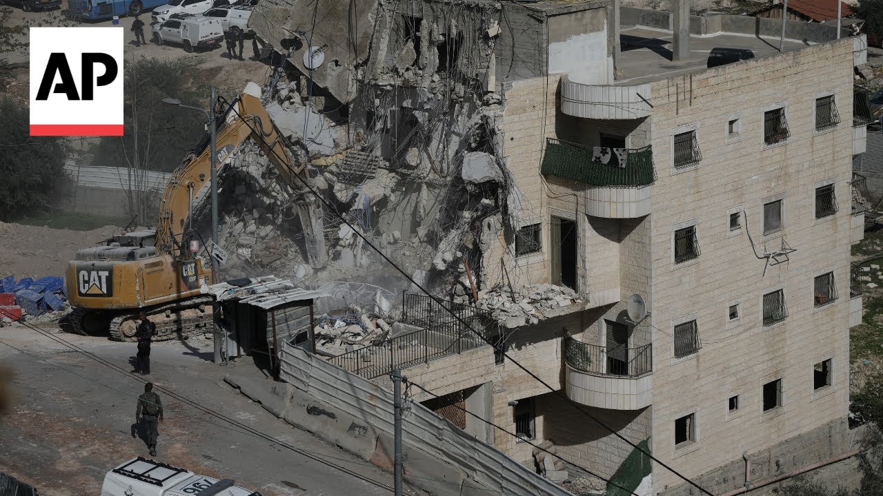 Palestinians watch in shock as Israel demolishes block of flats in Jerusalem